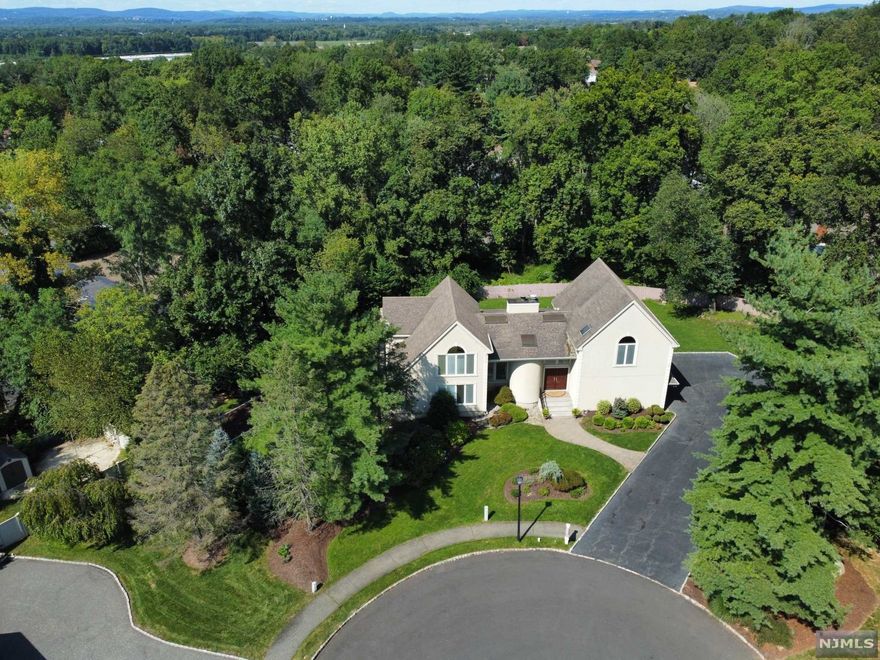 Remarks: Gorgeous 5BD, 3.5BA Contemporary colonial style home is meticulously maintained & located on a quiet cul-du-sac. This move-in ready home features HW floors throughout, dramatic vaulted ceilings for a grand feel & open floor plan for easy daily living & entertaining. Enter into the spacious foyer to the enormous sunken formal LR w FP & DR, FR, Custom gourmet kitchen w elegant rich ceiling height cabinetry, center island w sink, SS appliances, granite counters, lg pantry & sliders to the deck overlooking the backyard oasis w paver patio & FP; PR & laundry. Second floor is home to the Master suite w WIC & 3 add'l bedrooms & full bath. The full finished basement sets this home apart w a full bar, rec room, 5th bedroom, full bath, heated sunroom w access to the backyard & tons of storage. Walk to NYC bus.