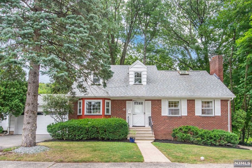 Welcome home to this charming colonial perched overlooking beautiful Booth Park and just 2 blocks to the vibrant Franklin Ave. Upon entering, you're ushered in through the large formal living room with centered stone fireplace, and views of the babbling waters Third River, walking paths, playgrounds, and green space. The formal dining room offers room for everyone to gather and share beautiful meals together. Following through the first floor, you'll enjoy a family room, eat in kitchen, half bath and large 2 car garage. Upstairs are 3 generous sized bedrooms, newer full bathroom and large hall closet, sky lights and a small balcony overlooking the park. The large basement with 2 finished spaces, one area features 1/2 bath and egress walk-out to the back. This home is bathed in sunlight from all directions and the back patio offers a lofty entreating area with stunning views and wrap around access. Enjoy all that Nutley has to offer with convenient access to town and transpiration.