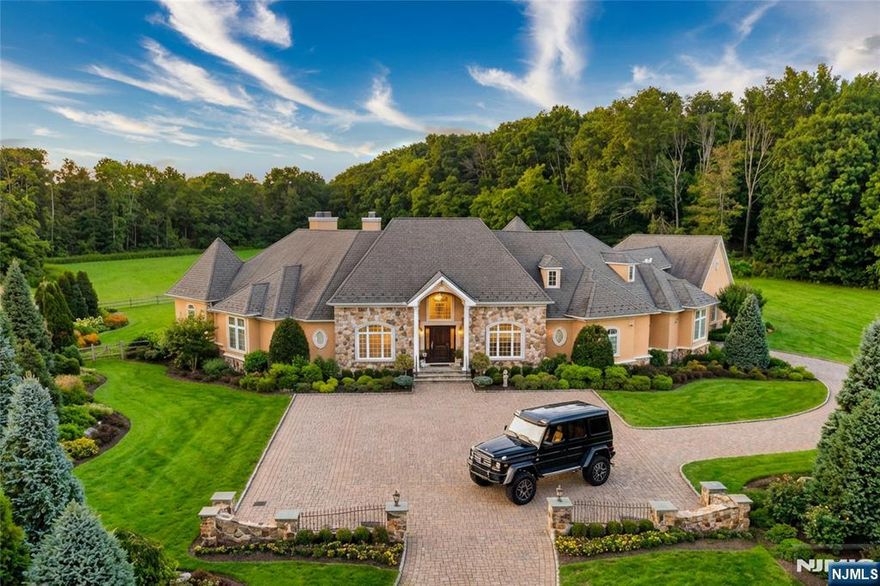 Set down a long private driveway on 6.81 acres, this luxury estate offers privacy and convenience near shopping, dining, and major travel routes. Featuring 5 bedrooms and 7 full and 1 half bathrooms, the open-concept layout showcases 24-foot ceilings, floor-to-ceiling windows, and a marble gas fireplace. The gourmet eat-in kitchen includes a large center island, Clive Christian-inspired cabinetry, granite countertops, high-end appliances, and a butlerâ€™s pantry with a wine fridge. The private primary suite offers a fireplace, sitting area, spa-style bath, and custom walk-in closet. Additional highlights include multiple en suite bedrooms, home theater, wine tasting room, custom bar, gym, 2,800+ sq ft storage, and an oversized 4-car garage. Resort-style outdoor living features 4,000+ sq ft of patio space, Pebble Tec pool, spa, fire bowls, and covered entertaining areas.