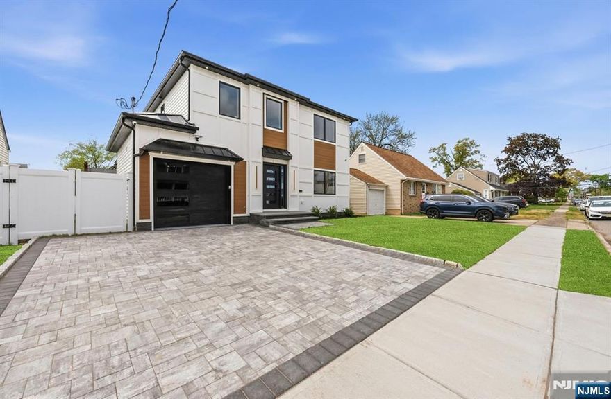 This thoughtfully designed residence rests on a prime location, blending timeless comfort with contemporary convenience. The first floor invites you into a welcoming living room, flows into a generous dining room, and opens to a modern kitchen adjacent to a versatile family room anchored by a custom fireplace-the heart of home life. A full bath on this level adds practical versatility for guests or daily living, while large windows invite abundant natural light and a sense of airiness. Upstairs, three spacious bedrooms offer retreat and restful privacy, complemented by a full bath and a convenient laundry room. The centerpiece is a lavish master suite featuring two walk-in closets and a full bath with a freestanding bathtub, a refreshing separate shower, and a double sink vanity designed for everyday luxury. The upper level provides comfort with thoughtful layout and ample storage.The finished basement expands living space with a full bathroom, ideal for entertainment, work from home, or recreation. Modern amenities include built-in cameras for security and built-in speakers for seamless ambiance throughout the home. This property combines practical modern systems with refined finishes, creating a welcoming, move-in-ready home. A rare opportunity to own new construction that feels timeless, bright, and endlessly adaptable.