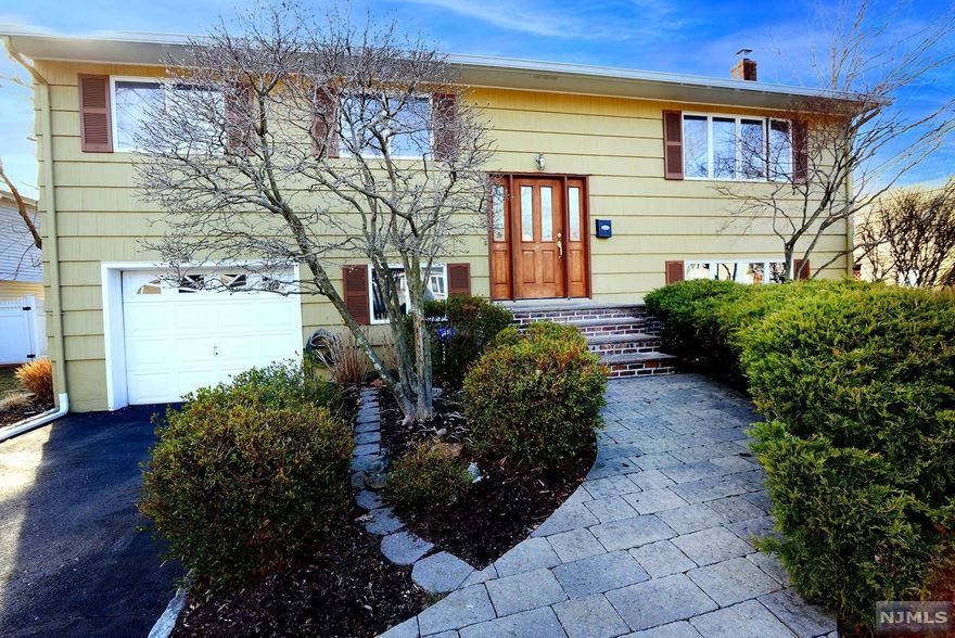 Welcome home! This split level home sits on a beautiful street in the desirable White Beeches section of Dumont! Tons of natural light throughout, with large rooms, and a cozy finished basement equipped with a wood burning stove. Gorgeous large lot (big enough for a pool) and covered patio make this house great for entertaining. Come make this house yours, you won't be disappointed!