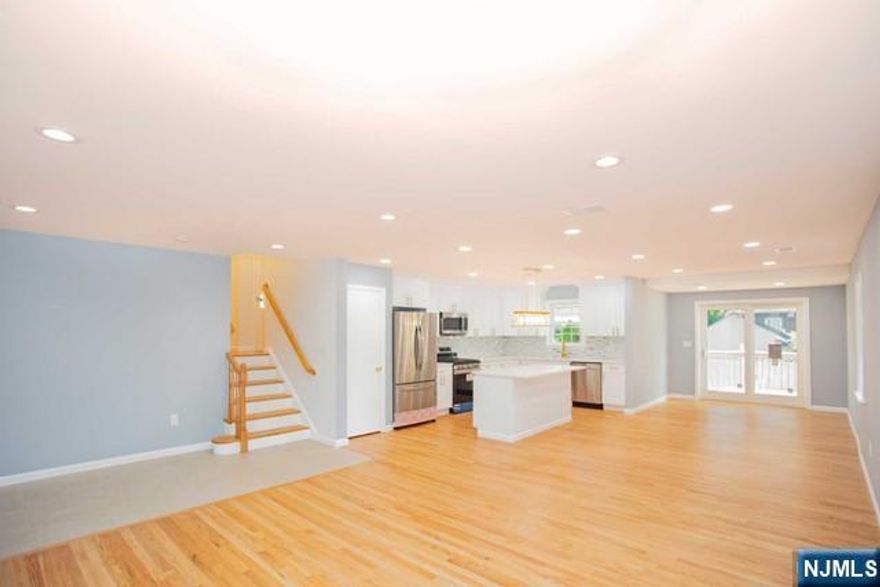 This property offers ample living space! Magnificent open floor plan, with gleaming hardwood floors that greets you on the main level, along with a massive living room, dining room, and kitchen with sliding doors leading to the oversized deck. Custom Kitchen designer cabinets, quartz counters, high end SS appliances, and huge island, graces this kitchen. The Master Suite is refreshing with its own full bath. The two additional spacious bedrooms share a full bath. The full basement level is not included. Use of the private yard and large deck is included, along with the comfort of Central AC, and so much more. Utilities included.