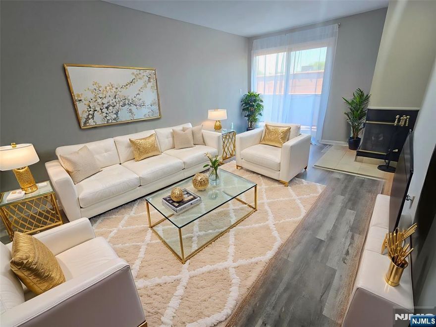 Just one block away from the New Downtown! Conveniently Located close to Bus Stop and walking distance to Essex St. Train Station. Newer Kitchen Cabinets and Quartz Counters, Soft-Close Cabinets and Stainless Steel Appliances. Large Living & Dining Area with Fireplace. New Flooring Throughout, Freshly Painted and Move-in Ready! Central Air, Private Balcony with entrances from Primary Bedroom and Living Room. Washer/Dryer in unit! Two Parking Spaces included! Just steps away from Hackensack Performing Arts Center, Restaurants, Stores and More! Listing agent related to owner.