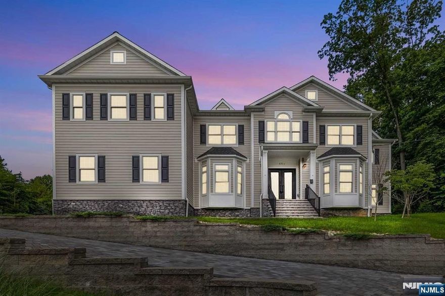 Step into a magnificent custom-built Colonial home boasting 5 beds & 5.5 baths. Nestled in the prestigious Upper Saddle River, this newly constructed residence spans over 5,500 sqft. Elegant double doors open into the breathtaking 2-story grand foyer. The curved stairwell sets the tone for the rest of the home. The 1st floor features: dining, living, office, and an impressive 1st floor suite with a full bath. The heart of this home lies in the gourmet kitchen, equipped with top-of-the-line appliances & seamlessly flowing into the grand room. Fireplace & custom built-ins create a warm atmosphere. Natural light floods the interior, accentuating the outdoor paver patio. A convenient butler's nook enhances your gatherings. Access the 2nd floor via either of the 2 stairwells, where you'll discover the primary suite with a spa-like bath, and 3 addts bed plus 3 full baths. Finished basement w/ a full bath. 3-car garage & more, this exceptional home offers the epitome of luxury living.