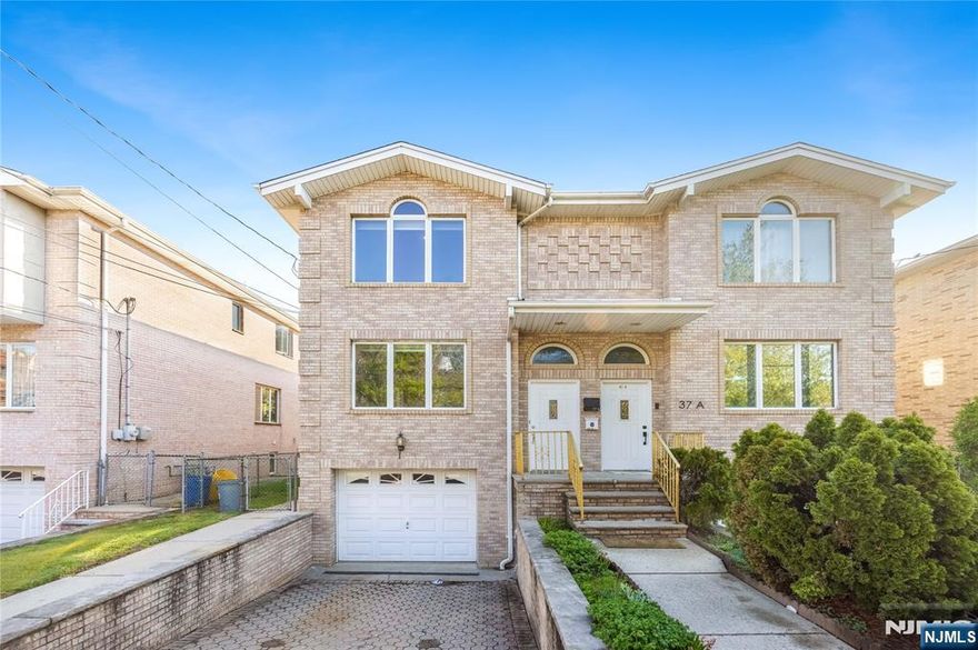 Bright and well-maintained half duplex on a south-facing lot with abundant natural light. Features a spacious living room, modern eat-in kitchen with access to the backyard deck, central A/C, and central vacuum. The second floor offers a primary bedroom with en-suite bath plus two additional well-sized bedrooms. Washer and dryer in unit. Newer appliances and freshly painted interior make this home move-in ready. Conveniently located near NYC transportation and shopping.