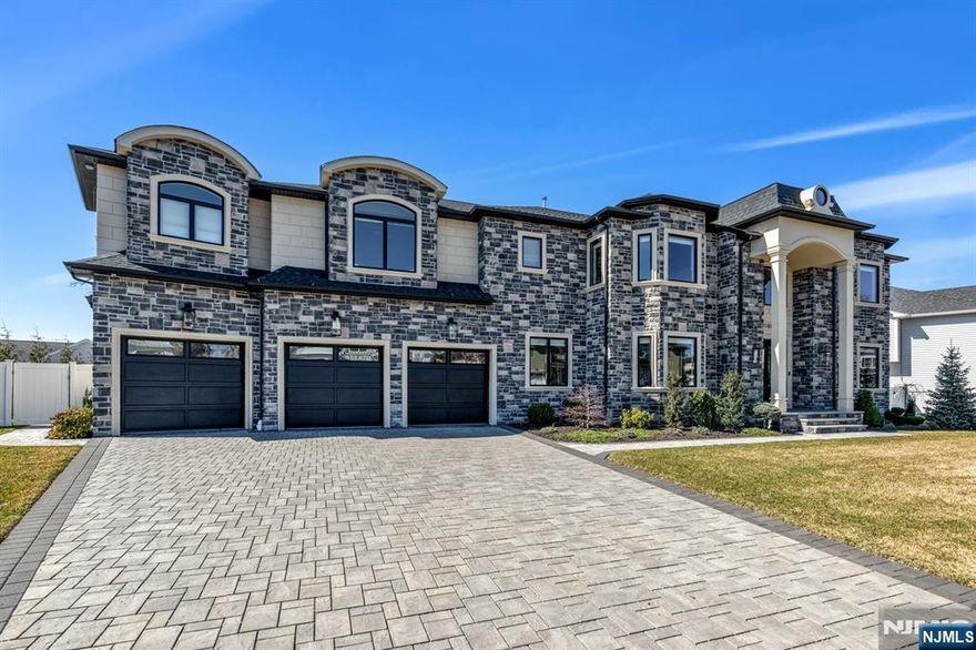 Stunning Paramus Colonial, built just 3 years ago, meticulously maintained and styled to perfection. This rare gem boasts a 3-car garage for the ultimate car enthusiast with epoxy floors and pre-wired for lifts. It offers 6 bedrooms and 5.5 bathrooms. A grand 2-story foyer welcomes you, flanked by formal LR & DR. The breathtaking great room with FP features a soaring wall of windows. Gourmet kitchen with a huge center island, Wolf & Subzero appliances. Wet bar connects Kitchen to DR. The 1st floor includes a bedroom suite and a home office. Upstairs, find 4 bedrooms, 3 full baths, & a convenient laundry room. Luxurious Primary retreat with double walk-in closets & a spa-like bath. A fully finished basement w. a home gym, rec room, bedroom, bath, & bonus roomâ€”perfect for a theater. Designer details shine throughout with custom wallpaper, elegant trim, & stunning tile work. The fully fenced backyard features a large patio. Enjoy Paramus' low taxes, vibrant community, & premier shopping!