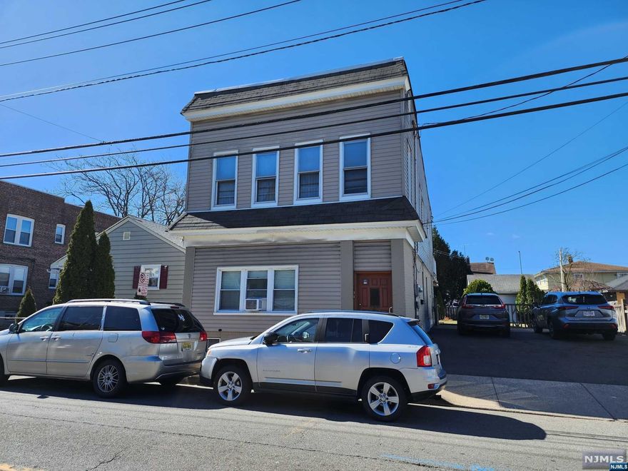 Two family home in a desirable neighborhood. This very well-kept home features three bedrooms on second floor as well as an extra room which can be used for an office or playroom, separate utilities, garage, and parking for up to four cars. Live in on unit and collect rent from the other. Must see!!