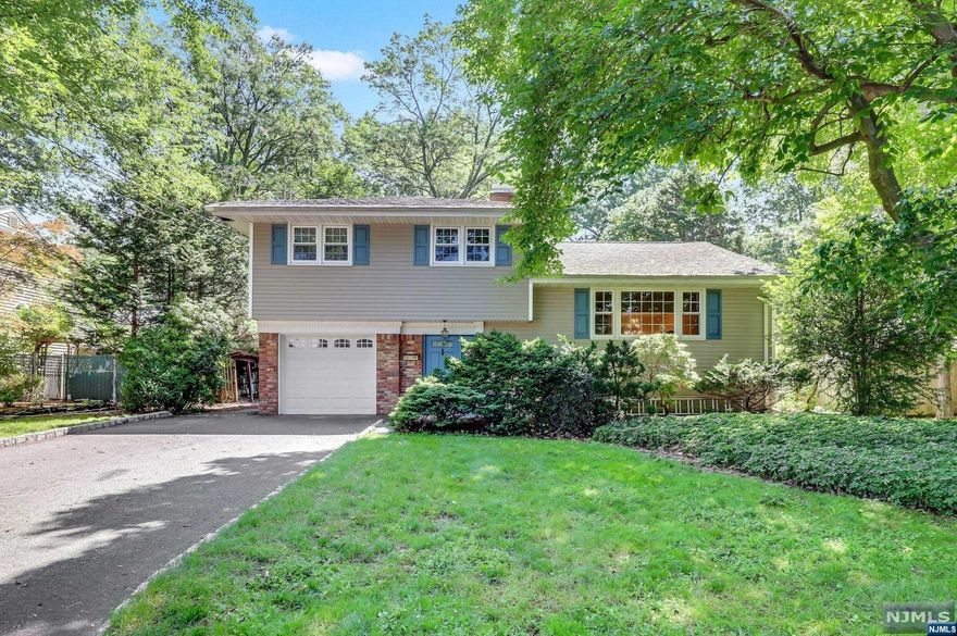 Located in Sought After town with highly rated schools is this expanded Deceiving Sugar Maple Split Home! must see inside! Beautiful Location! Tree-lined street on one of the most historic streets in town! Walkable to downtown/shopping and to the Middle School. Expanded home with open concept Living/Dining/Kitchen and Family Rooms. Hardwood floors are stylishly throughout main level. Updated Kitchen with solid wood cabinets and granite countertops, peninsula for additional prep space. Open to Family Room with huge bay windows facing backyard, wood stove and access to patio and backyard. Ground level Den with wood burning stoves with access to yard and large full bathroom, great for overnight guests. Walkout to large paver patio. Upstairs are 3 bedrooms and full bath, hardwoods under carpet. Full Basement too! Partially finished but SO much potential! Fenced in property and spacious garage. Must see!