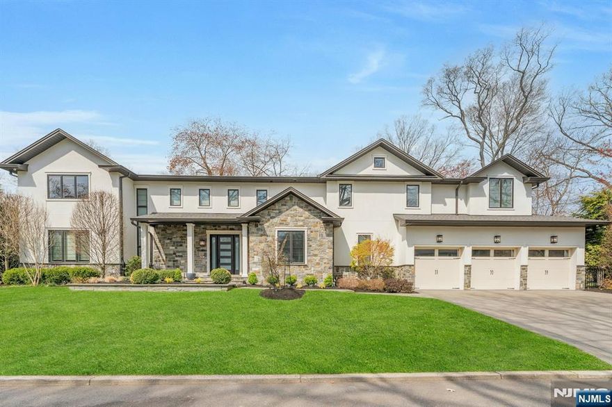 Builder's own custom home (2017), this 7-bedroom, 5-bath Colonial blends contemporary styling, luxury, and refined living across three finished levels on a private .36-acre lot in the heart of Demarest. The main floor welcomes guests with a grand two-story entry and flows into a light-filled, open-concept layout with 10-ft ceilings, large picture windows, wide-plank hardwood floors, and a gourmet kitchen appointed with quartz countertops and a large island â€” all overlooking the eat-in area and family room with sliding glass doors leading to a bluestone patio and professionally landscaped, fully fenced back yard screened by mature evergreens. A formal living room with fireplace, formal dining room, bedroom/office, full hall bath, and mudroom with access to the 3-car garage complete the main level. Upstairs, the primary suite features a spa-like bath with soaking tub, separate shower, dual sinks, and a private balcony, plus a junior suite, two bedrooms sharing a Jack-and-Jill bath, a second spacious family room with fireplace, and laundry. The large finished lower level adds a rec room with wet bar, home theater, two bedrooms, a full bath, and high ceilings. Additional features include, but are not limited to, radiant heat in 4 of 5 bathrooms, a house generator, and multi-zone HVAC. Award-winning Demarest Schools and Northern Valley Regional High School, close to NYC, parks, and shopping. Don't be late for this exceptional offering!