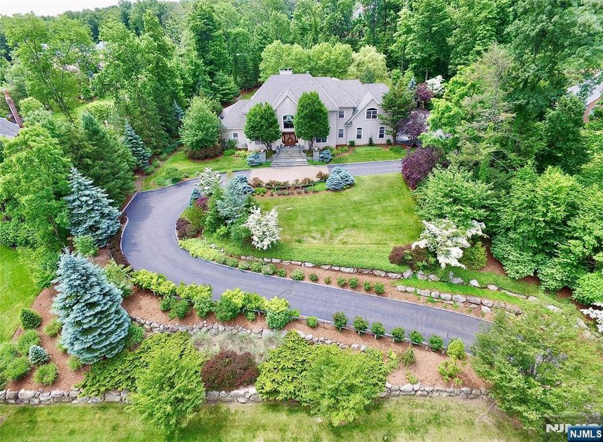 Custom Designed Manor on almost 2 acres of private property in Mahwahâ€™s prestigious Rio Vista. This extraordinary 10,000 sq ft residence is not simply a home; it is a celebration of artisanship, scale, and refined living. Solid mahogany doors welcome you into a dramatic foyer, with sweeping curved staircase which rises with sculptural perfection, impeccably cut solid wood spindles and trim. The foyer flows into a soaring living room, where radiant heat continues seamlessly from marble to hardwood floors. A magnificent floor-to-ceiling feature fireplace is flanked by huge windows which fill the room with natural light. Ceiling molding? Carved from a single piece of solid wood, creating a level of craftsmanship rarely seen today. The formal dining room showcases an intricate inlaid floor of maple and walnut, setting the stage for elegant entertaining. The West Wing primary suite is its own sanctuary, complete with fireplace, private patio, 2 walk-in closets, and immense bathroom (easily could be dual baths). Sophisticated black walnut study. Expansive cherry chefâ€™s kitchen, with island, pantry, and ready for the culinary enthusiast. Second level with 4 beds, 3 baths, theatre and games room. The 3rd level is set as a performance arts stage. Finished basement with party/bar, games, bedroom 6 and bathroom. Built with integrity and intention, this is a home that stands resolute, grand, warm, beautifully detailed, and created to last for generations, just waiting for your touche