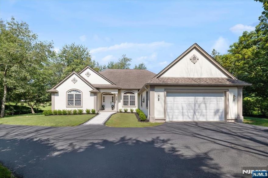 Contemporary style ranch home offers four generous sized bedrooms with three and a half bathrooms. Upon entering you are greeted with a beautiful feature window at the center of the home offering tons of natural light. The skylights and cathedral ceiling add to the airiness of the open floor plan that is comfortable for daily activity along with being the ideal setting to host all your gatherings. Hardwood floors throughout, custom cabinetry, pellet fireplace and fully finished basement complete this stately property. The house is situated on beautiful flat land that is fully fenced in and backs up to the Crystal Springs golf course with water views and NO HOA FEE.