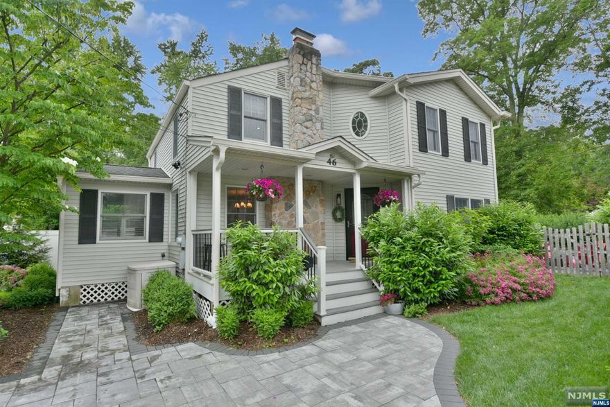 The one you've been waiting for! This exceptional move in ready three bedroom 2.5 bath home features a crisp modern vibe. Freshly painted in a neutral color palette with gorgeous new hardwood floors throughout, this home has a stunning primary en suite with two walk in closets and a brand new primary bath that will take your breath away. Open first floor with spacious living room, charming dining room with fireplace, a den and an eat in kitchen with abundant cabinetry, stainless steel appliances and granite counters. First floor laundry and powder room. Amenities include a front porch, central air, underground sprinklers, water softener, professional landscaping, paver driveway. Level fenced in yard - your dog will love it. Inviting patio - perfect for summer grilling. This one is sure to spark joy! Don't hesitate.