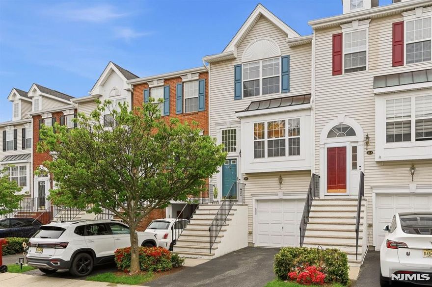 Impeccably RENOVATED and truly turnkey, this designer-updated townhome in the highly sought-after Cambridge Heights community offers approximately 1,800 sq ft of beautifully finished living space. A welcoming foyer leads to the main level, where refined finishes and thoughtful design shine throughout. The stunning kitchen features custom wood cabinetry, elegant countertops, stainless steel appliances, and a sunlit dining area with a charming window bench. The open-concept living and dining area is ideal for entertaining, showcasing high ceilings, hardwood floors, recessed lighting, and a gas fireplace. A stylish powder room completes this level. Upstairs, the spacious primary suite offers two oversized closets and a beautifully renovated en-suite bath. The second bedroom is bright and generously sized with double closets, complemented by a fully updated *NEW* hall bath, laundry area, and linen storage.The lower level provides additional living space with direct access to a private patio and an expansive, open backyard an exceptional setting for both relaxed everyday living and effortless entertaining. Additional highlights include a brand new roof (April 2026), garage access, ample storage, and abundant guest parking nearby. Enjoy resort-style living with a pool, clubhouse, fitness center, tennis courts, and beautifully maintained grounds all just steps to NYC direct bus service and approximately 9 miles from Manhattan, with convenient access to major highways.