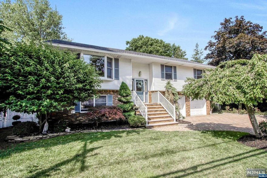 Gorgeous 4-BR home with so much curb appeal in River Vale. Large living room, open to dining room featuring sliding doors to deck. Spacious eat-in kitchen including wood cabinets. Large primary suite with updated primary bath. Two spacious bedrooms and an updated full bath completes the main level. The lower level offers a large family with brick fireplace and door to the covered deck. Summer eat-in kitchen with wood cabinets. Fourth bedroom and updated full bath completes ground level. Lush, picturesque property offers a huge backyard and two-level deck-great for entertaining! Beautifully designed paver driveway and 2-car attached garage. Great extended family home. Close to parks, schools, restaurants, transportation, and the town of River Vale.