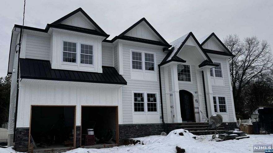 Welcome to a stunning brand new construction on existing foundation in Paramus! This remarkable 5-bedroom, 5-bathroom,2 half bathroom home, built on an existing foundation, boasts quality craftsmanship and premium materials. A 2-story foyer welcomes you, leading to a formal living room and dining room, ideal for entertaining. The 2-story family room is filled with natural light, featuring a gas fireplace and access to a tranquil backyard. The first level also includes a large guest suite and a gourmet kitchen equipped with top-of-the-line appliances. Upstairs, discover a primary suite complete with a spa-like bathroom fireplace, and two walk-in closets, alongside two junior suites, another bedroom, a full bath, and a laundry room. The finished basement offers a rec room, theater-ready room, and a half bath. Located close to amenities, this home combines luxury with convenience. Owner has RE License