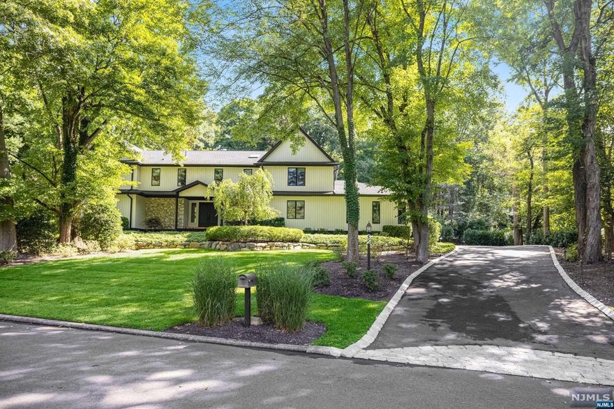 A stunning contemporary Colonial high on the Knoll overlooking Ho-Ho-Kus. This elegant home is completely renovated with additions in 2016. An open-concept floor plan with a grand 2-story family room w/vaulted ceilings, exposed beams, and a wood-burning fireplace awaits. The gourmet kitchen is a chef's dream, boasting a Wolf 4-burner gas cooktop with griddle, quartzite countertops, a Sub-Zero fridge, Wolf oven, two half dishwashers, and a wine cooler. The primary bedroom suite is conveniently located on the first floor, offering direct access to the serene backyard. Outside, enjoy a resort-style retreat with an in-ground gunite heated pool, a pool house with a full bathroom, and a beautifully landscaped patio. The fully renovated basement features a movie theater, commercial gym, dry sauna, game room, sitting area, and a large walk-in closet, making it perfect for entertainment and relaxation.