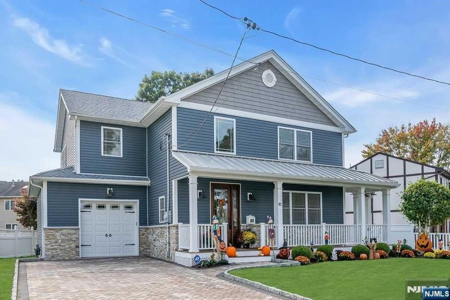 Welcome HOME! This stunning Custom Modern Farm House Style Colonial has everything your heart desires. Wrap around porch to the deck. Grand entry features an 8' Tall Solid Mahogany Front Door, a 2 Story Open Foyer with 9' ceilings, Coiffured DR Ceilings, Stone Gas Fire Place, Hard wood floors throughout with Mahogany Inlays. Chef's Eat in Kitchen features Granite Counter Tops, SS appliances, Large Island, Pot Filler, Farm Sink and entrance to mud room that leads to garage. Custom Built Butler Pantry with wine/coffee bar. Master suite features tray ceilings, luxury spa bath with large shower, jacuzzi tub, custom double vanity, tile and wainscoting. Second floor laundry, Fully finished basement, professionally landscaped yard, paver block driveway, sprinkler system, central vac, maintenance free porch/deck. This home offers all the architectural details of a one-of-a-kind-home! A must see!