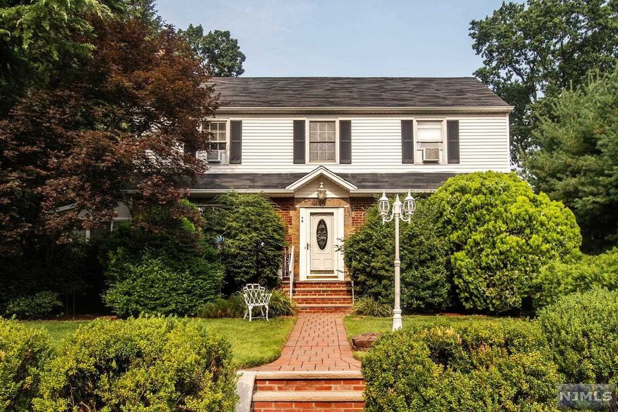 Classic oversized center hall colonial situated in the Graphic Boulevard section of Bergenfield. Upon entering walk into the entry foyer, opens to spacious formal living room with fireplace, formal dining room, bright and sunny den, eat-in kitchen, 1/2 bath. Hardwood floors throughout. Upstairs master bedroom, plus 2 more good sized bedrooms and a full bath. Oversized lot 80 x 100. Lovely private yard with patio. Finished basement with full bathroom. Truly a spacious home (approximately 1700 sq. ft.). A must see to appreciate this lovely home.