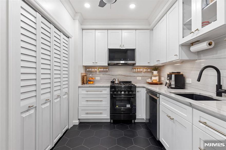 Private patio living in the sought-after Hamilton Park area of Downtown Jersey City, this beautifully renovated two-bedroom home combines modern upgrades, classic architectural charm, and an exceptional location just moments from all Jersey City offers. Situated on the first floor of a well-maintained boutique three-unit pet-friendly building, this thoughtfully designed residence offers approximately 851 square feet of comfortable living space along with a private covered patio featuring a retractable awning and lighting - perfect for outdoor dining, entertaining, or relaxing. The designer-renovated kitchen showcases quartz countertops, white shaker-style cabinetry, subway tile backsplash, under-cabinet lighting, stainless steel appliances, and striking black hex tile flooring. A brand-new in-home washer and dryer adds everyday convenience. The bright living and dining areas feature bay windows, crown molding, recessed LED lighting, and dark-stained hardwood floors. Both bedrooms are well-proportioned, with the primary bedroom offering a custom closet system. The second bedroom works perfectly as a guest room or work-from-home office The bathroom has been tastefully updated with classic white subway tile and a Carrara marble-top vanity. Additional highlights include efficient mini-split heating and cooling, ceiling fans, and a large under-stair storage closet. For added buyer confidence, the seller will provide a one-year home warranty through Assurant at closing