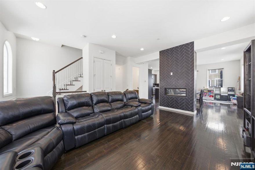 Exquisite luxurious townhome in Bergen County's prime town. This prestigious townhome redefines opulent living with an expansive 4 bedroom, 3.5-bath layout across three levels. Crafted for the discerning buyer seeking grandeur and privacy, every detail is timeless elegance and modern sophistication. Property highlights open-concept living with fully upgraded kitchen. High ceiling,s ample sunlight, double sided fireplace adds luxurious touches to the home. Signature Features *Expansive open-concept area showcase a LAVISHLY tiled kitchen & a STATEMENT tiled fireplace, perfect for hosting & quiet retreats. Bespoke Upgrades *Elegantly finished and painted 2car finished garage and a private 2car driveway. *Luxe carpeted stair runners for comfort & safety. *Custom windows with pull-down sun blockers for light control and insulation. *Fortified deck for outdoor lounging & entertaining. *State-of-the-art double zone WiFi thermostats for smart climate control. Elite Inclusions (At Seller's Discretion) The property includes HIGH END Bosch appliances. An optional Guardian security suite (featuring indoor, driveway, and doorbell cameras) is also available with enrollment. Many additional inclusions will make this an ideal living for families looking to strive a This turnkey masterpiece offers unmatched luxury with proximity to NJ Transit, direct NYC bus access, local boutiques, and cultural landmarks. Reach out today for your exclusive viewing.