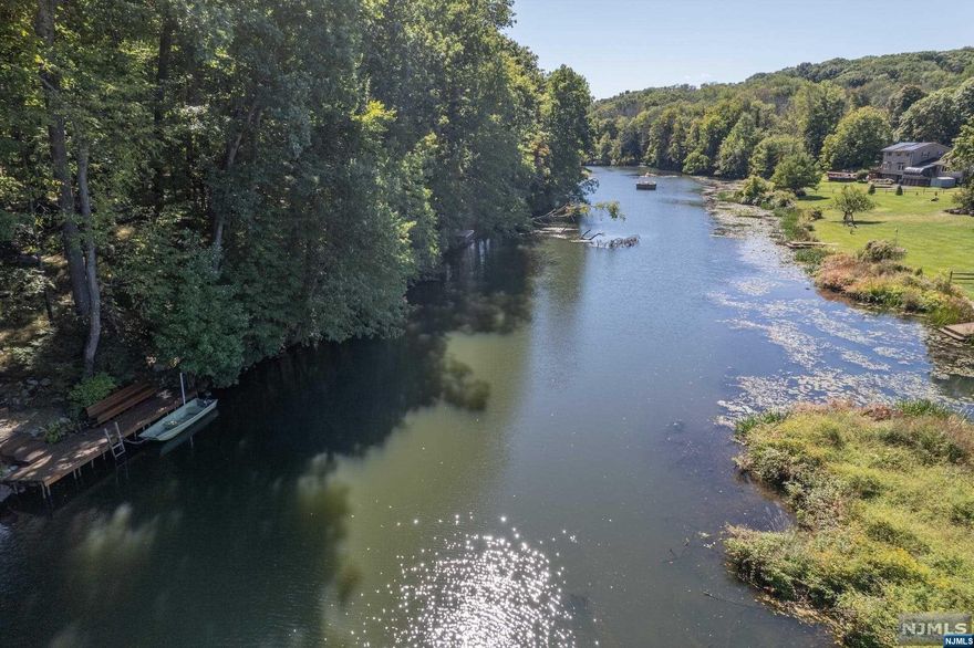 Great location with river access! If 174 foot of Rockaway River frontage appeals to you-then your prayers have been answered. Location and setting of this classic colonial are perfectly situated on one of Boonton Township's best cul-de-sac streets. This 1+ acre parcel offers large flat yard with circular drive, garage around back, second detached garage, covered front porch, 2 front entrances, walk out basement, screened porch, deck and more. The interior layout is timeless, functional, and just the right size. Large living room, formal dining room with built in corner cabinet, updated newer kitchen, 4th bedroom or office, and screened in porch all on 1st floor. Then you move to the lower level offering finished family room with fireplace, workshop, utility room and laundry access - plus garage and door to rear yard. A must see home in A+ location with low taxes and great schools. $125 annual fee for street association, beach property maintenance.