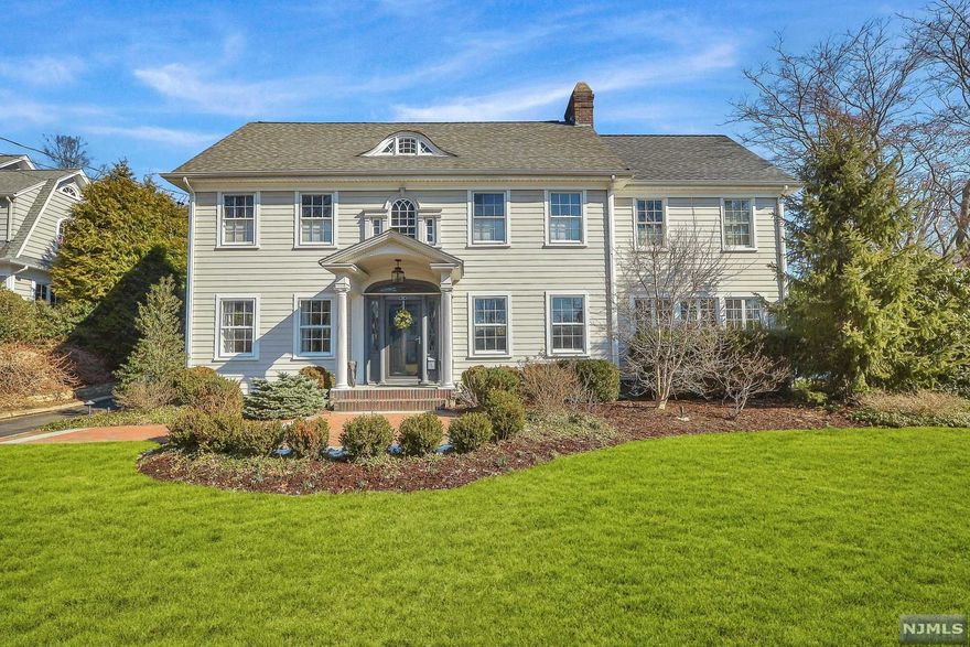 This extraordinary home, sitting proudly on over a half acre on a premiere Ridgewood street, blends classic style with modern luxury. The updated gourmet kitchen with seating island opens onto a private patio ideal for entertaining. Three of the 6 bedrooms are en suite, offering options for family and guests. The primary suite with abundant closets and glorious bath, also has a fireplace for those cozy evenings at home! Minutes from Willard Elem and Ridgewood's top-ranked schools, NYC train, bus transportation, and our bustling downtown. Hardie Plank exterior, landscape lighting, and room for a pool! This property will appeal to the most discerning buyer.