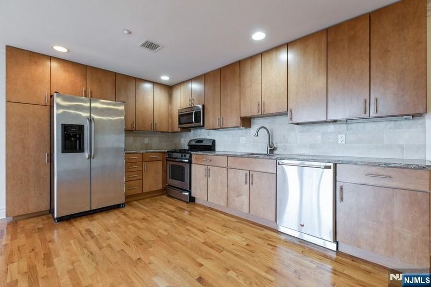 Welcome to The Gate! This is a 1021 sft 2 bed/1-1/2 bath. The unit is in a modern, 5 story, brick, elevator building just 2 blocks from the Rutherford train station and close to the bus stops. Each unit offers hardwood floors, crown and base moldings, granite countertops, stainless steel appliances, washer/dryer in unit, keyless entry, private balcony, central A/C and video intercom. Pet friendly up to 40lbs with a one-time, non-refundable $350 pet fee. Gated parking available - $100/month for an uncovered spot, $150/month for covered, non-garage parking. PHOTOS ARE OF 505 WHICH IS THE SAME FLOOR PLAN ON A DIFFERENT FLOOR.