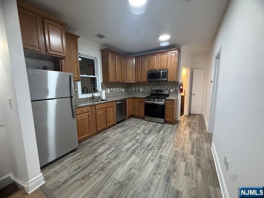 Great second floor apartment recently updated, located within a close proximity to NYC transportation, schools, parks and shopping areas! This apartment features a living room, dining room, kitchen, 2 bedrooms, 1 bathroom and washer and dryer hook-ups on the second floor. Upstairs you will find additional room that could be used as a play room or a family room! Central A/C, one parking spot included in rent!