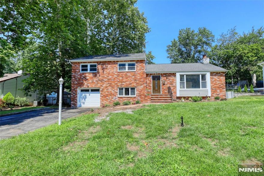 Pack your bags and move into this beautifully updated split-level home featuring 4 bedrooms and 3 bathrooms. Nestled on a quiet, tree-lined street, itâ€™s just minutes from parks, steps away from NYC transportation, and a short distance to schools. The home boasts a newer kitchen, updated bathrooms, fresh paint, and refinished hardwood floors. The inviting living room includes a wood-burning fireplace, while the formal dining room opens to a spacious family room with skylights and a cathedral ceiling. The ground floor offers a bedroom and a newly renovated full bathroom, perfect for guests or extended family. Outside, the large fenced backyard features a newer patioâ€”ideal for entertaining or relaxing.