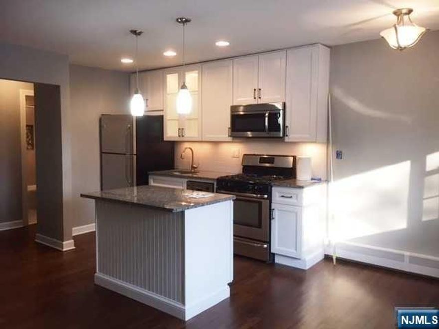 A beautifully renovated one bedroom condo with newer state of art open kitchen, granite counter tops, center island, stainless steel refrigerator, dishwasher, stove, microwave. Custom cabinetry with beautiful lighting effects, dining area, newly redone hardwood floors, new baseboard heating covers, new wall a/c. Great convenient location to shopping, NYC transportation and all major highways. Laundry room on premises, The rent also includes heat, gas, hot & cold water. One assigned parking spot. Great value!!