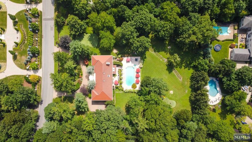 LOCATION LOCATION LOCATION! If you've ever dreamed of your own private retreat in the prestigious & sought-after Rio Vista section of Alpine, then you know how rarely this opportunity comes along! Only 8 miles from the GWB, you feel worlds away from the stress & bustle of the city. Set on 2.21 lavishly landscaped acres with a spectacular pool and Terrace, the sweeping estate beckons as you arrive at the grand gated entry. Boasting low taxes, an open floor plan, grand entry w/vaulted ceilings & hardwood floors throughout. The open Kitchen and sunken family room provide an abundance of living space to entertain. Luxuriate in your massive Primary Suite w/twin terraces overlooking the glittering pool & expansive patio. A walk out lower level allows for easy access to roam the park-like property or even practice your golf game on the putting green! Live your dreams on one of the most spectacular locations in Alpine.