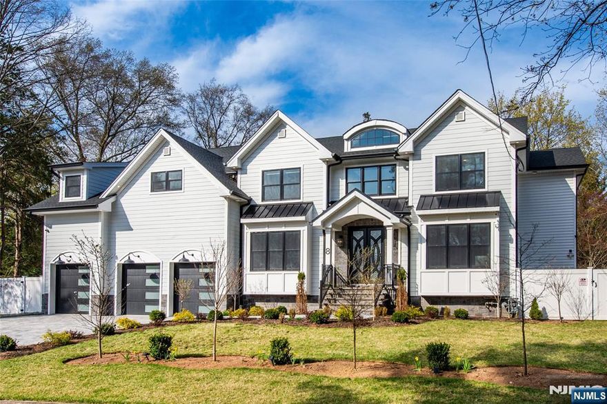 Enter into pure luxury on a quiet dead end street in the East Hill of Demarest. This home is minutes to NYC via the GWB, nearby parks, and in a top rated school district feeding Northern Valley Regional HS at Demarest. It offers 4,140 sqft above grade plus 1,510 sqft of finished lower level space on a 0.319 acre lot. With hundreds of thousands in post construction upgrades, the home features a variance approved extra wide driveway leading to a 3 car garage, stone accented exterior, and Andersen windows throughout. Walnut stained oak floors anchor the main level with a chef's kitchen featuring Statuario quartz, Sub Zero, Wolf, a Cove dishwasher, and a walk in pantry. Every plumbing fixture is House of Rohl, burnished gold in the kitchen and polished chrome in each bath. Gas fireplace, kitchen island, paver patio, and fully fenced yard make it easy to entertain, while a first floor junior suite offers multigenerational flexibility, and a powder room completes the main level. Upstairs, the primary suite offers dual walk in closets, cove lighting, motorized shades, and a spa bath, plus two junior suites, a fifth bedroom, and a hall bath. The radiant heated lower level adds a rec room, home gym, wet bar rough in, bonus room, and a full bath. Also included: 50 AMP EV charger, 8 camera CCTV security, whole house water filter and water softener, and Generac ready transfer switch. Virtual Tour link contains the full gallery, video tour, and spec sheet. Book your private showing today.