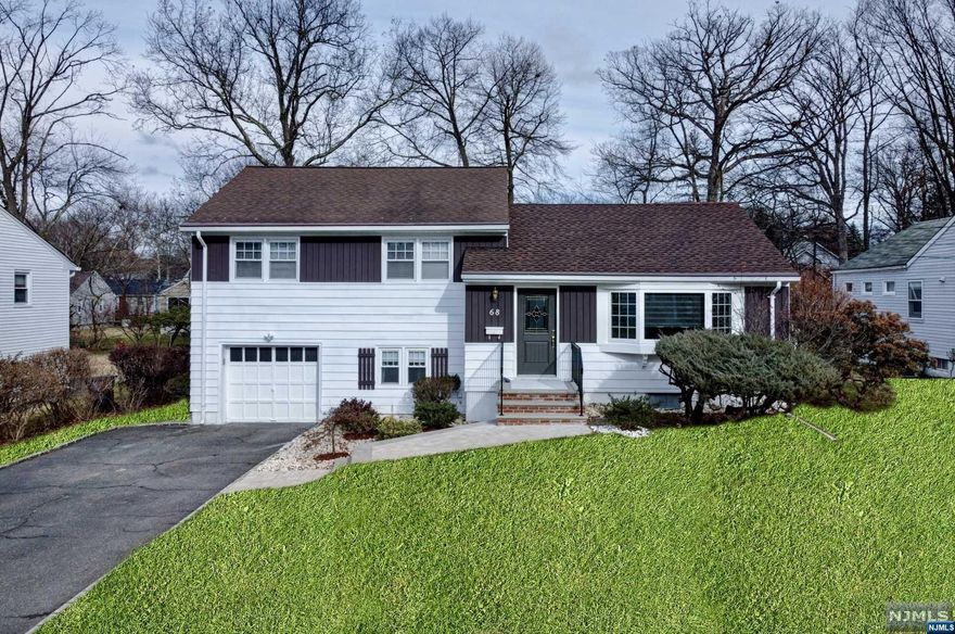 This beautiful recently renovated 3 Bed, 2.1BA gem on a flat fenced in lot is loaded with designer features and modern day decor throughout and is nestled in the heart of an exceptional neighborhood. The open kitchen features custom wood cabinets, SS appliances, tile backsplash and granite counters. It opens up to the Din Rm that has access to the screened in 3 season porch for year round entertaining. The spacious Liv Rm features new bay window inviting natural light to illuminate the space. Ascend a few steps to the upper level featuring 3 spacious Bed Rm and a generously sized shared Ba with glass shower enclosure. The lower level includes an office, powder rm, laundry rm & access to 1 car garage. Enjoy peace of mind with many recent upgrades incl. new windows, new roof, new front steps, water softener & recently installed furnace & AC. Conveniently located close to the town center with wonderful shops & restaurants, top-rated schools, parks, Houses of Worship & NYC bus access