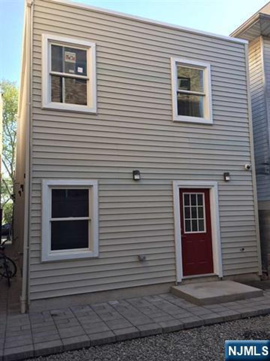 Stunning Washington Park 2 bedroom town home with a private entrance and backyard. Open concept floor plan with 9 Ft ceilings that opens up into your own patio and backyard. Kitchen features custom cabinets and stainless steel appliances. In-unit washer/dryer with plenty of closets and storage. Close to elevator to Hoboken, light rail and bus to Manhattan. Plenty of street parking. Must See!!