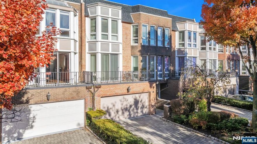 Experience refined modern living at Kensington Park -- Fort Leeâ€™s only gated residential neighborhood. This beautiful 4-bedroom, 3.5-bath townhome offers 2,410 sq ft of light-filled interiors that blend timeless design with everyday comfort. The southeast-facing residence enjoys a tranquil, tree-lined setting just minutes from New York City, featuring a distinctive multi-level layout ideal for entertaining and privacy alike. The entry level includes a spacious family room, built-in closets, and sliders to a brand-new stone paver patio, plus a laundry room and an oversized 2-car garage with abundant storage. The main level showcases a bright living room with fireplace, wet bar, terrace access, an office, and a formal dining room. The brand-new kitchen impresses with stainless steel appliances, quartz countertops, and custom cabinetry, complemented by a powder room. Upstairs, the primary suite features abundant natural light, three closets, and a luxurious bath, while two additional bedrooms share a full bath, plus beautiful skylights. Built later than most homes in the community, this residence is among the newest in Kensington Park. Enjoy the community pool, playground, and proximity to plenty of restaurants, shopping, top-rated schools, and NYC transitâ€”the perfect combination of comfort, elegance, and convenience.