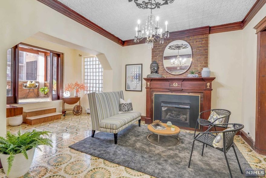 Great opportunity to own this meticulous preserved, solid brick single-family home located in West New York, NJ; just off from the prestigious Boulevard East! Enter through a spacious foyer, bursting with natural sunlight, leading to a seamless and elegant vintage designed Living Room with an originally structured gas burning brick fireplace, high ceilings featuring original chandelier medallion an enclosed, glass framed Sunroom with views of New York City; leading to a formal Dining Room also with high vaulted tray ceilings. The large EIK features an open floor plan with a stylish dinette area, steel appliances, custom cabinets, free standing chef's Island, adjacent to a spacious family room also with an originally structured gas burning Fireplace, leading to a private backyard and Deck. Second floor features a large Main-Bedroom complete with en-suite Bathroom, jacuzzi tub, free standing frameless shower, Mediterranean style cabinets with marble counter tops