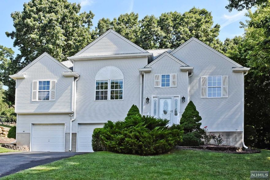 Welcome to this Gorgeous well maintained bi-level, featuring 4 generous sized bedroom, 3 full bathrooms with hardwood floors throughout. Walk into your wide open living room with vaulted ceiling and gas fire place. Updated kitchen providing plenty of cabinet space and stainless steel appliances, leading to your updated trek 2 story deck with an above ground swimming pool with heater and ready available gas line for your grill perfect to entertain. The lower level includes 1 bedroom, full bathroom, a rec room which is currently used as a gym but can be made any desired space that may FIT your need. Spacious backyard with inground 6 zone sprinkler system featuring 2 sheds and enclosed garden with its own water system. Spacious 2 car garage with plenty of storage pace. Close to Rockaway Townsquare, Dover's NJ Transit Train station and Route 80. come make this spectacular house into your new home!