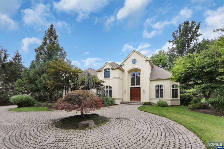 This perfectly landscaped Center Hall Colonial w/approx. 4,775 interior sq. ft. is a Builder's Home that exudes modern elegance. The gorgeous paver style circular driveway welcomes you to this 6 bdrm (including Primary & Jr. Suite), 4.5 bath home. Open floor concept floor plan w/ floor to ceiling Andersen windows throughout. Tons of natural sunlight filter through the kitchen windows displaying updates, wet bar & wine chiller. The elegant FDR is perfect for entertaining. Radiant heat on entire 1st flr as well as in primary bdrm & spa like primary bath w/ jacuzzi tub. 2 Story FR w/10 ft. ceilings. Lower level walkout offers marble flooring/fireplace/lots of storage, movie theatre, and room for office/hobby room. All new Trek decking and new railings on main level and primary bedroom. Spacious 3 Car Garage. Close to Blue Ribbon schools, shopping, parks, and restaurants. Minutes to the GW Bridge.