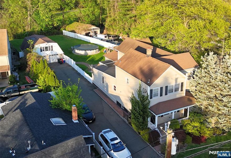 Welcome to this exceptional and beautifully maintained two-family home, offering the ideal blend of comfort, functionality, and investment potential. Situated on an expansive lot, this residence is perfect for multigenerational living or generating rental income. The first unit spans approximately 2,000 sq ft, showcasing four generously sized bedrooms and two full bathrooms. The second unit offers two bedrooms and two full bathrooms across approximately 1,200 sq ftâ€”each space thoughtfully designed with high-end finishes including gleaming hardwood floors, granite countertops, marble vanities, custom cabinetry, and refined crown molding throughout. Step outside to your own backyard retreat featuring a saltwater pool, stylish patio pavers, and a fully fenced yardâ€”an entertainerâ€™s dream or the perfect spot to relax. The extended driveway easily fits 10+ vehicles, and the detached two-car garage includes a finished loft space ideal for a home office, studio, or gym. Each unit has its own gas and electric meters, along with private in-unit laundry for maximum convenience. Located just minutes from major highways, excellent schools, and the scenic Saddle Brook County Park, this property combines luxury living with everyday practicality. A true turnkey opportunityâ€”whether youâ€™re looking to live, rent, or both. Come see the possibilities!