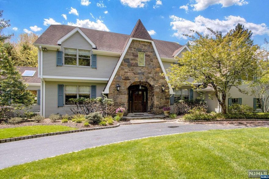 Stunning Colonial, nestled on an exquisite property.Beautiful entryway with winding staircase and French door to spacious office. Large formal living room. Impeccable gourmet kitchen w/ radiant heat, high-end stainless appliances, granite countertops, and center island make this chef's kitchen. Great room features vaulted ceilings and stone fireplace. Banquet-sized formal dining room with custom fireplace. Spacious laundry room, mudroom, and 2 half baths round off the first level. Second level offers primary suite w/ fireplace, 2 walk-in closets, and primary bath w/ double vanity, jetted tub, and separate shower. Junior suite with modern full bath, an additional bedroom and updated full bath. Private guest suite with 2 bedrooms, full bath, and separate staircase, completes this level. Finished lower level with rec area, family room, gym, bonus room, full bath and storage.Stunning landscaped property and paver patio with fire-pit. Elegant circular driveway and 3-car garage.