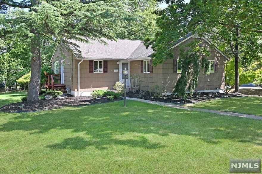 Welcome to this lovely 3 bedroom, 2 bath expanded ranch style home set on a manicured property with mature plantings. This spacious home has many special features including hardwood floor throughout, a kitchen with granite countertop and stainless appliances, an open, spacious, and bright living room with plenty of windows, and a dining room with a door leading to a deck that overlooks the large backyard. The main bedroom with full bath, 2 additional bedrooms and a full hallway bath completes this level. The basement is finished and has a large recreation area, an office room, laundry, and 2 car garage. This beautiful and updated home is conveniently located close to NYC transportation, schools, shopping, and more. A must-see!!