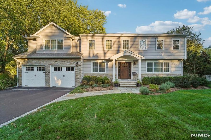 Welcome to 46 Van Blarcom Lane, a stunningly renovated and expanded residence (2015) that perfectly blends modern luxury with everyday comfort. The crown jewel of this property is the resort-style backyard, featuring an expansive paver patio with a stylish pergola, a beautifully landscaped private yard, a pool, and deck - perfect for entertaining. Inside, the sun-drenched open floor plan boasts a chef-inspired kitchen with a massive dark wood island, professional-grade stainless appliances, and a seamless transition into a great room with a dining and living area with vaulted ceilings and a floor-to-ceiling stone fireplace. The 2nd floor offers 5 spacious bedrooms and 3 full baths, including a primary suite retreat with a tray ceiling and a spa-like bath featuring a freestanding soaking tub and custom glass shower. The finished walkout basement adds incredible versatility as a recreation room or home theater, complete with a full bathroom. Built for efficiency, tech-forward ease, peace of mind, this home includes a 7-zone high-efficiency heating system, a whole-house generator, built-in speakers, tankless water heater, water softener, whole-house filtration, and a high-efficiency heat pump for the pool. From the elegant formal living and dining rooms with custom millwork to the practical laundry chute and underground sprinklers, every detail has been meticulously curated. A turnkey masterpiece in a prime location!