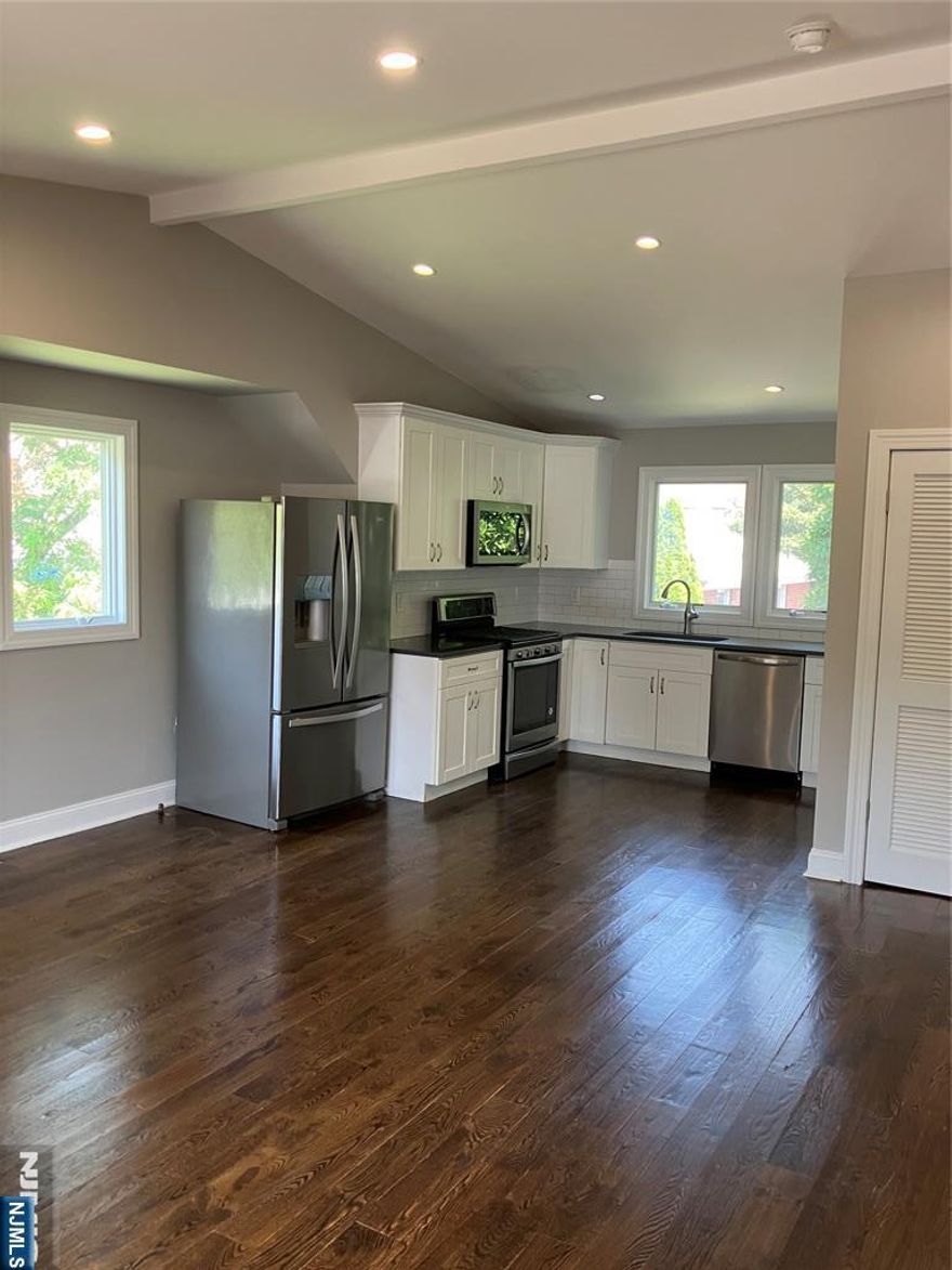 Beautifully renovated 2BR 2BTH in great commuter location....just steps from the express bus to NYC!!! Enjoy the convenience of a private side entrance leading into an airy, open layout with vaulted ceilings and gleaming hardwood floors. The renovated kitchen features quartz countertops, a stylish subway tile backsplash, and stainless-steel appliances. The spacious primary suite includes a modern en-suite bathroom, while the second bedroom is equally roomy and paired with another updated full bath. Additional features include central air and heat, ample closet space, an in-unit washer and dryer, as well as shared use of the backyard!!! Best of all, the unit comes with a private 1 car garage which can be block creating an additional parking space in the driveway!!! Sorry, not cats allowed, but landlord would consider a small dog!!! Available for August 1st occupancy, this a rare find at a great price!!!