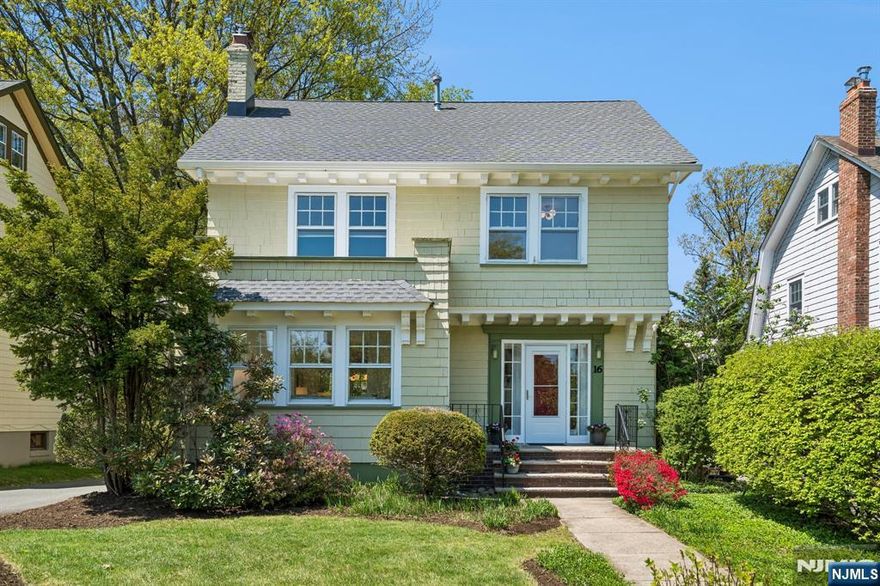 Welcome to this exceptional home in the heart of Upper Montclair Village. Situated on a quiet, tree-lined street, this property offers a true neighborhood feel while being just blocks from shops, cafes, parks, the library, top-rated schools, and convenient NYC-bound bus and train service.This charming five-bedroom Colonial features a welcoming front porch and timeless architectural details, including hardwood floors and classic moldings throughout. The spacious living room with a wood-burning fireplace flows seamlessly into a charming sunroom and a formal dining room with a window seat. The updated kitchen is designed for both function and style, offering stainless steel appliances, custom cabinetry, two large skylights, and a generous pantry. A bright breakfast area with built-in seating opens to a deck overlooking a spacious, level backyard ideal for entertaining or everyday enjoyment. The second floor includes four well-proportioned corner bedrooms and a full bath. The third level provides flexible living space with a recreation room, fifth bedroom, sink with potential for future bath, and ample storage. Additional features include a new roof, two-zone central air conditioning, and a detached two-car garage. With multiple options for home offices, bonus spaces, and entertaining areas, this home effortlessly blends classic charm with modern convenience.