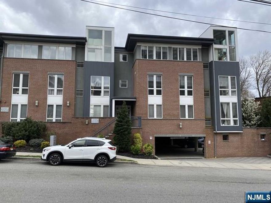 Spacious and stunning 2 bedroom, 2 bath condo ,high ceilings, two story corner windows with partial views of the Hudson River and New York City. This beautifull unit offers two generously sized bedrooms and two full bathrooms, all hardwood floors. Enjoy the comfort of central air, the convenience of in unit laundry, and a large kitchen complete with stainless steel appliances and granite countertops. Includes two indoor parking spaces (11 & 12). Ideally located just minutes from NYC public transportation, Edgewater ferry, Restaurants,Shops, Parks and much more.