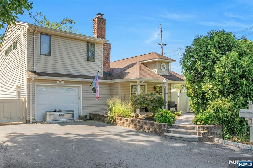 Wonderful opportunity to own this charming home on a rare double lot! A welcoming front porch and paver walkway set the tone before stepping inside to a spacious living room with fireplace, seamlessly connected to the dining area in an airy open-concept layout. The fully renovated kitchen boasts granite countertops, a slate backsplash, and sleek modern finishes. The first floor also includes a large bedroom and full bathroom, ideal for those seeking convenient one-floor living. Upstairs, the generously sized master suite impresses with soaring ceilings, skylights, and a private master bath, creating a perfect private retreat. Outdoors, the oversized fenced yard is perfect for entertaining, gardening, or simply relaxing. With a double lot offering potential for expansion, the possibilities are endless. Located on a wonderful street, this home is great for commuters with nearby buses and train service, plus easy access to shops and excellent restaurants. Donâ€™t waitâ€”make this your dream home today!