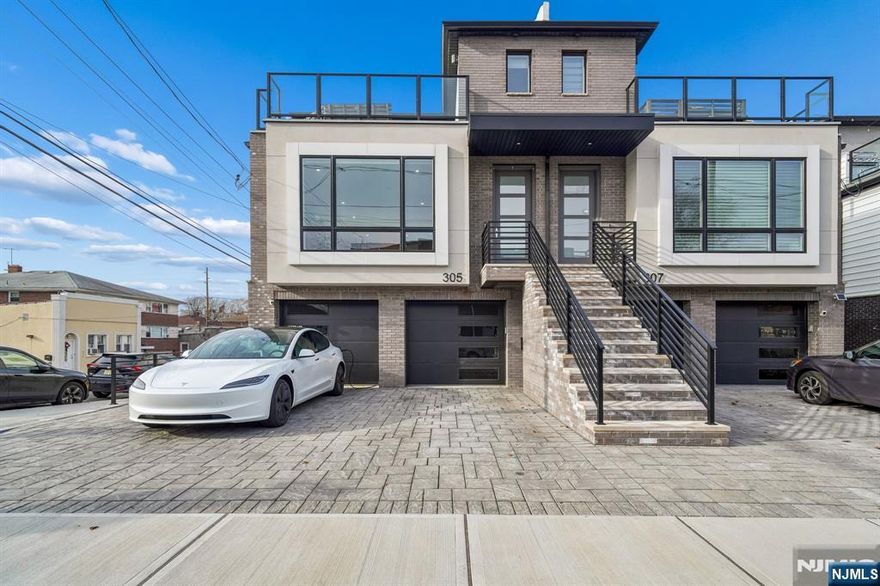 Welcome to this refined newer-construction townhouse where modern architecture meets thoughtful luxury. This elegant three-bedroom, two-and-a-half-bath home showcases a seamless open-concept design with sun-drenched living spaces, wide-plank hardwood flooring, and bespoke finishes throughout. The chefâ€™s kitchen is both functional and striking, featuring quartz countertops, custom cabinetry, stainless steel appliances, and a statement center island ideal for entertaining. The primary suite offers a tranquil retreat with generous proportions and a spa-inspired en-suite bath appointed with a double vanity and glass-enclosed shower. Secondary bedrooms are equally well-appointed, providing flexibility for guests, home office, or growing needs. An exceptional highlight is the private outdoor deck with a built-in kitchen and grill, creating a rare opportunity for elevated outdoor living and entertaining. Additional features include garage parking, in-unit laundry, recessed lighting, central air and heat, auto shades and a striking contemporary exterior. Conveniently located near shopping, dining, parks, and transportation to New York City, this home delivers both sophistication and convenience in equal measure.