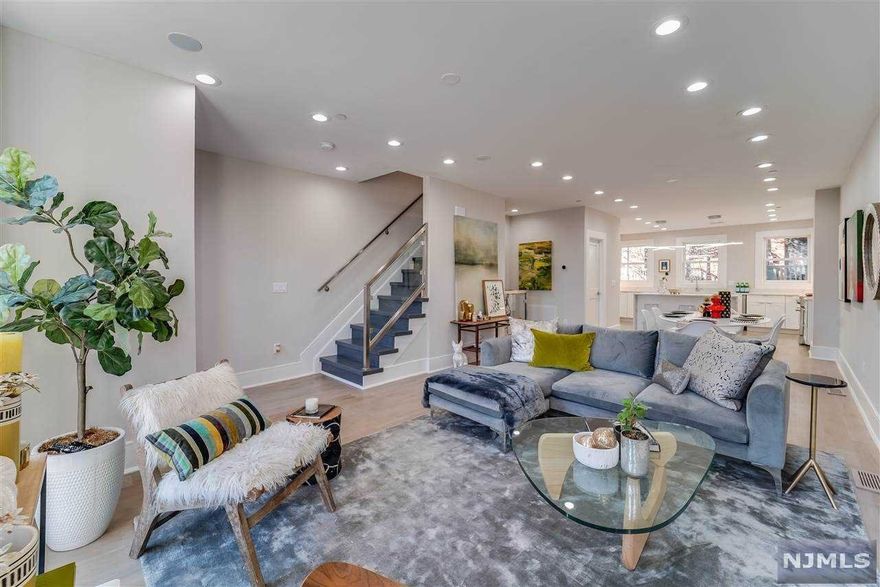 Spectacular south facing, newly renovated 4 story townhome ideally located in the heart of downtown Jersey City. This pristine home features four spacious bedrooms, four and half baths, floor to ceiling Marvin windows, designer lighting, staircases with modern glass handrails, two-zone central heat/air conditioning and wide plank hardwood floors throughout. The open concept parlor level features an expansive living area with an ethanol fireplace, chic powder room, oversized dining area and a chef's kitchen including white custom cabinetry, quartz island and countertops, Sub Zero fridge, Miele dishwasher and built in coffee maker and much more... The second level has two large bedrooms, and bathrooms, one with an en-suite bath and both with large walk-in closets. The sun drenched skylit third floor boasts a private master suite complete with beverage center, a view of Lady Liberty, an expansive walk-in closet and a luxurious spa-like master bathroom.