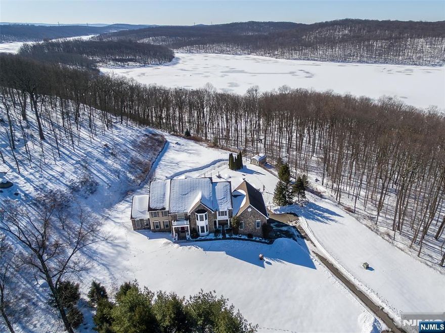 Serenely Nestled at the end of a Quiet Cul-De-Sac you will find this Hidden Treasure on a Sprawling 3.87 Acre Premium Lot with Spectacular Views of the Reservoir from almost every Room. Exquisitely Designed and Built with Thoughtful Scale and Superior Craftsmanship Across 5,473 Sq Ft of Living Space. The Sweeping Staircase Welcomes you and is Open to the Two-Story Great Room with a Gas Fireplace, Surround Sound and Walls of Windows for the Light to come Streaming Through. A Formal Living Room & Formal Dining with a Tray Ceiling, A Main level Office, A Conservatory for Entertaining, Powder Room & a Beautiful Kitchen with Granite Counter tops, SS Appliances, a large Center Island & a Separate Dining Area. A Spectacular In-Law Suite with a Bedroom area, Living Room, Full Bathroom & a Walk- In Closet. The Luxurious Primary Bedroom Suite Offers a Sitting Room area, Tray Ceiling, Vanity Area, Large Walk - In Closet & a Primary Bathroom with Two Vanities, Jacuzzi Tub & Shower Stall. A Bedroom with an En-Suite & Two Bedrooms with a Jack & Jill Bathroom. The Walk -Out Lower Level offers a High Ceiling, Plumbed for a Bathroom. & Plenty of Storage. Custom Crown Moldings Throughout, Hardwood Floors, Whole House Generator. A Pristine Heated In-Ground Pool, Firepit & a Large Shed with full Electric. Kinnelon offers Top Rated Schools Year after Year and is close to Shopping, Golf Courses, Parks, Transportation and Major Highways. If you are looking for Serenity, this is the House for You! .