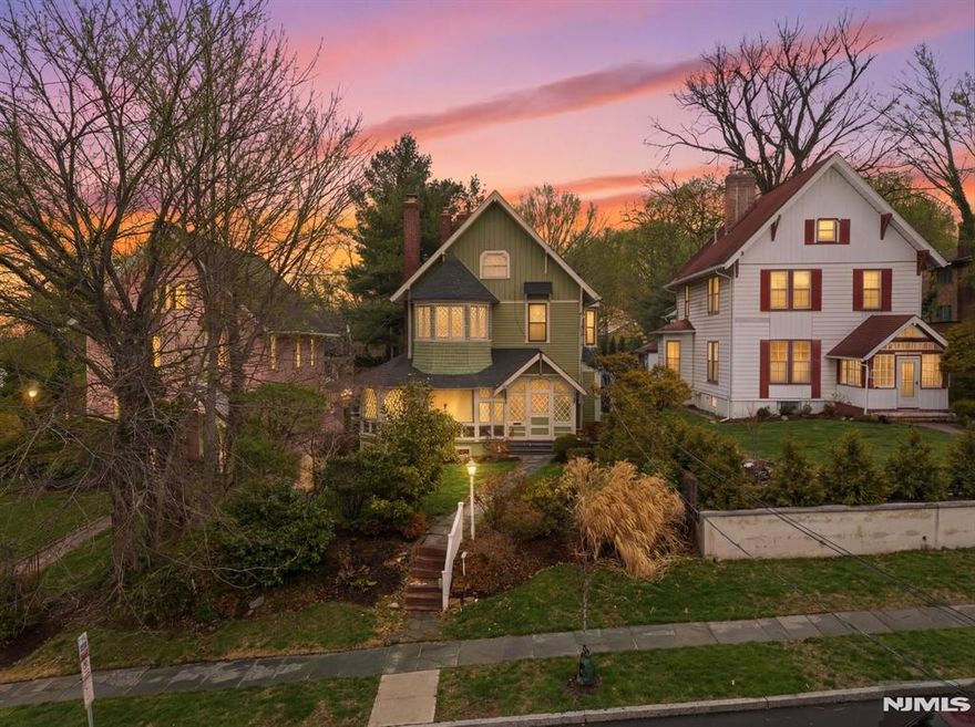 Welcome to Palisade Manor, where Gingerbread Victorian charm and modern updates blend across three full levels of living, creating a timeless space for warmth and entertaining just steps from downtown Englewood - one of NJâ€™s most sought-after towns. An enclosed wraparound porch sets the tone, leading into a light-filled interior with soaring ceilings, intricate moldings, original hardwood floors, and 3 wood-burning fireplaces. The main level flows seamlessly from the living room to the formal dining room and into a private study with French doors, offering an open yet functional layout. The renovated chefâ€™s kitchen features cherry cabinetry, granite countertops, stainless steel appliances, dual sinks, a center island, and a secondary butlerâ€™s staircase for added convenience. The second floor boasts a primary suite with fireplace, bay window sitting area, and spa-like bath with tub and separate shower, while additional generously sized bedrooms include an enclosed Florida room off the 3rd bedroom above the rear deck. The third floor provides flexible space for bedrooms, office, or gym. A full, clean, unfinished walkout basement offers storage and future potential. Modern comforts include a 2-year-old water heater, multi-zone central A/C, natural gas heat, public water and sewer. Private rear driveway parking off Hillside Ave., close proximity to downtown shops, dining, and parks, etc. Bus to NYC directly in front of house on Palisade make this the ultimate commuter's dre